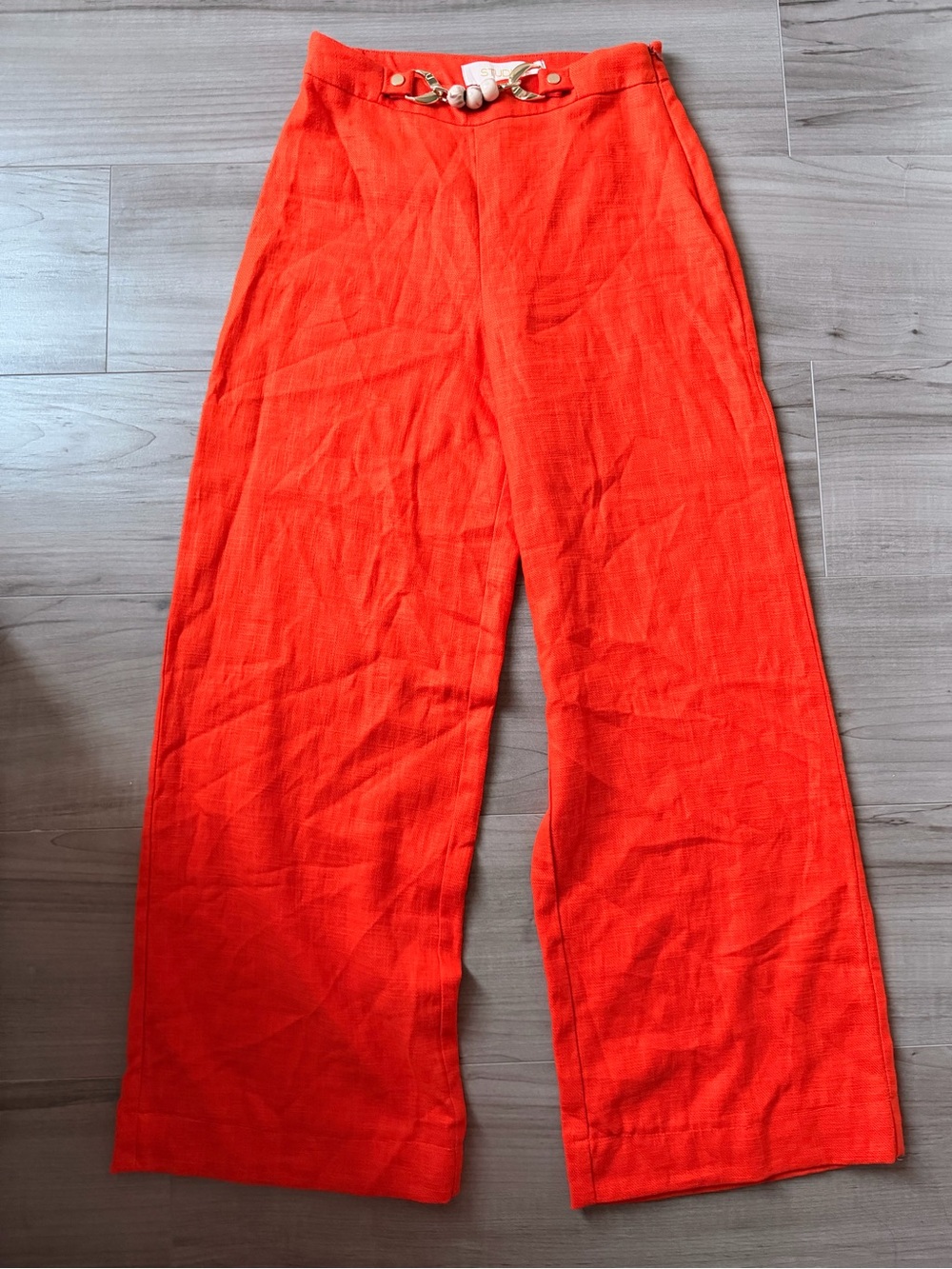 Studio F Orange Wide-Leg Pants with Gold Chain Detail